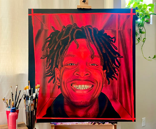 bright red portrait Painting of rapper 21 savage on an easel with art supplies in the foreground.
